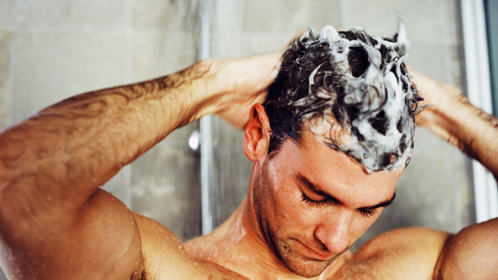 Patient gently washing hair after a hair transplant following doctor recommended aftercare instructions. First Hair Wash After Hair Transplant